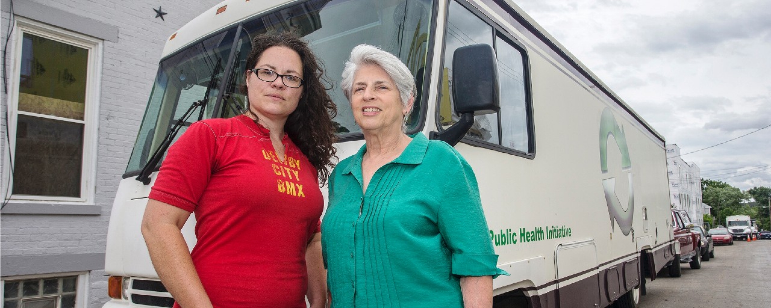Dr Judith Feinberg and Libby Harrison stand in front of the Cincinnati Needle Exchange RV.