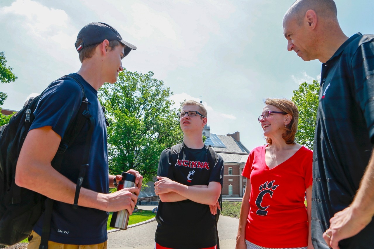 The Steins pause along campus to talk with a family friend.