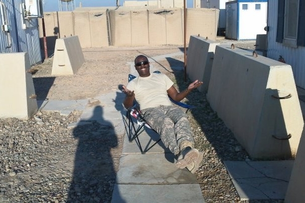 Terence Harrison relaxes in Iraq sitting in chair.