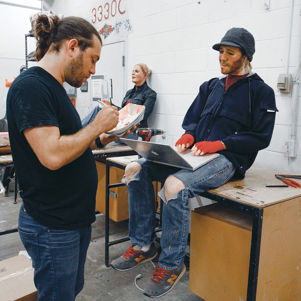 Alan Marrero touches up his sculpture Ethan