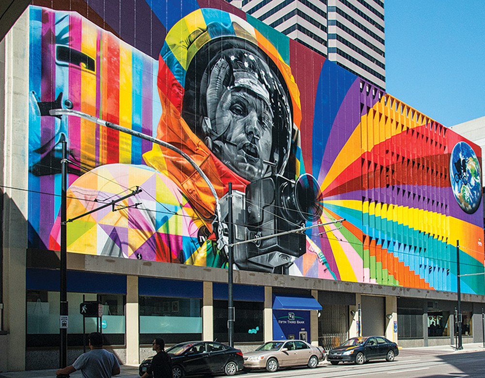 A colorful mural of Neil Armstrong on the side of a building in Cincinnati