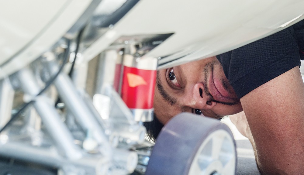 A member of the team that created a prototype pod for high-speed travel peers underneath the machinery.