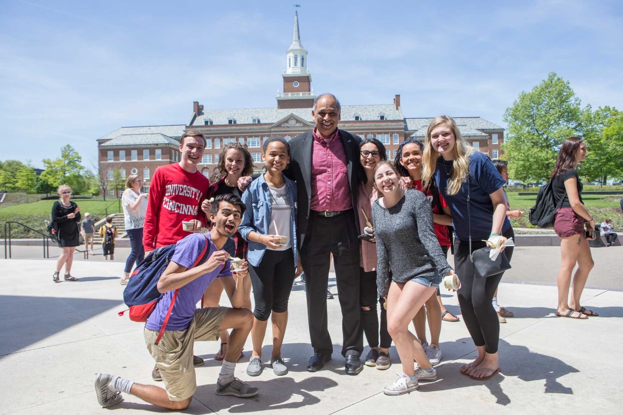 UC students and President Pinto with McMicken Hall in background.