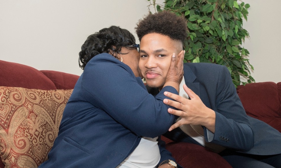 Betty Jones gives Alberto Jones a kiss on the cheek.