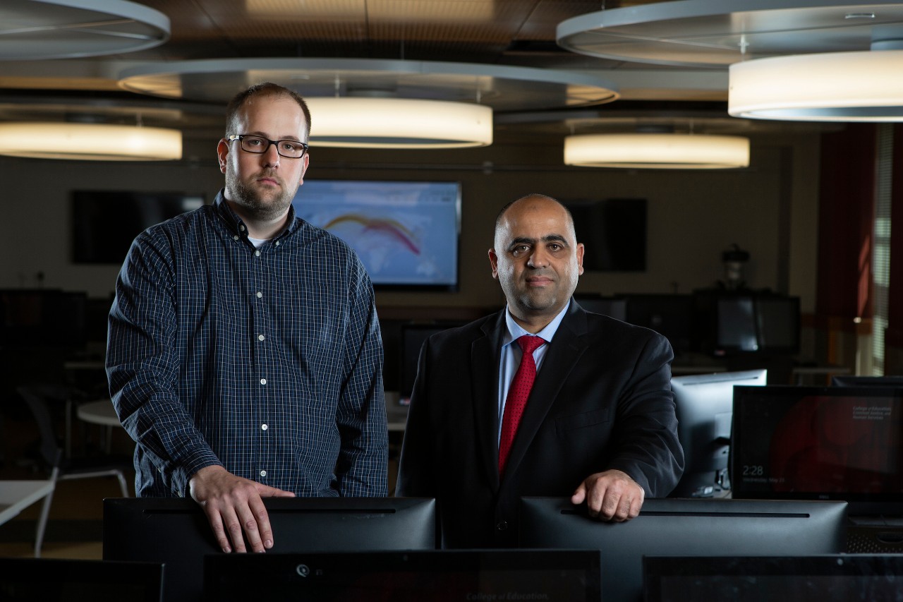 Jason Gerst and Hazem Said stand inside a lab in the School of Information Technology