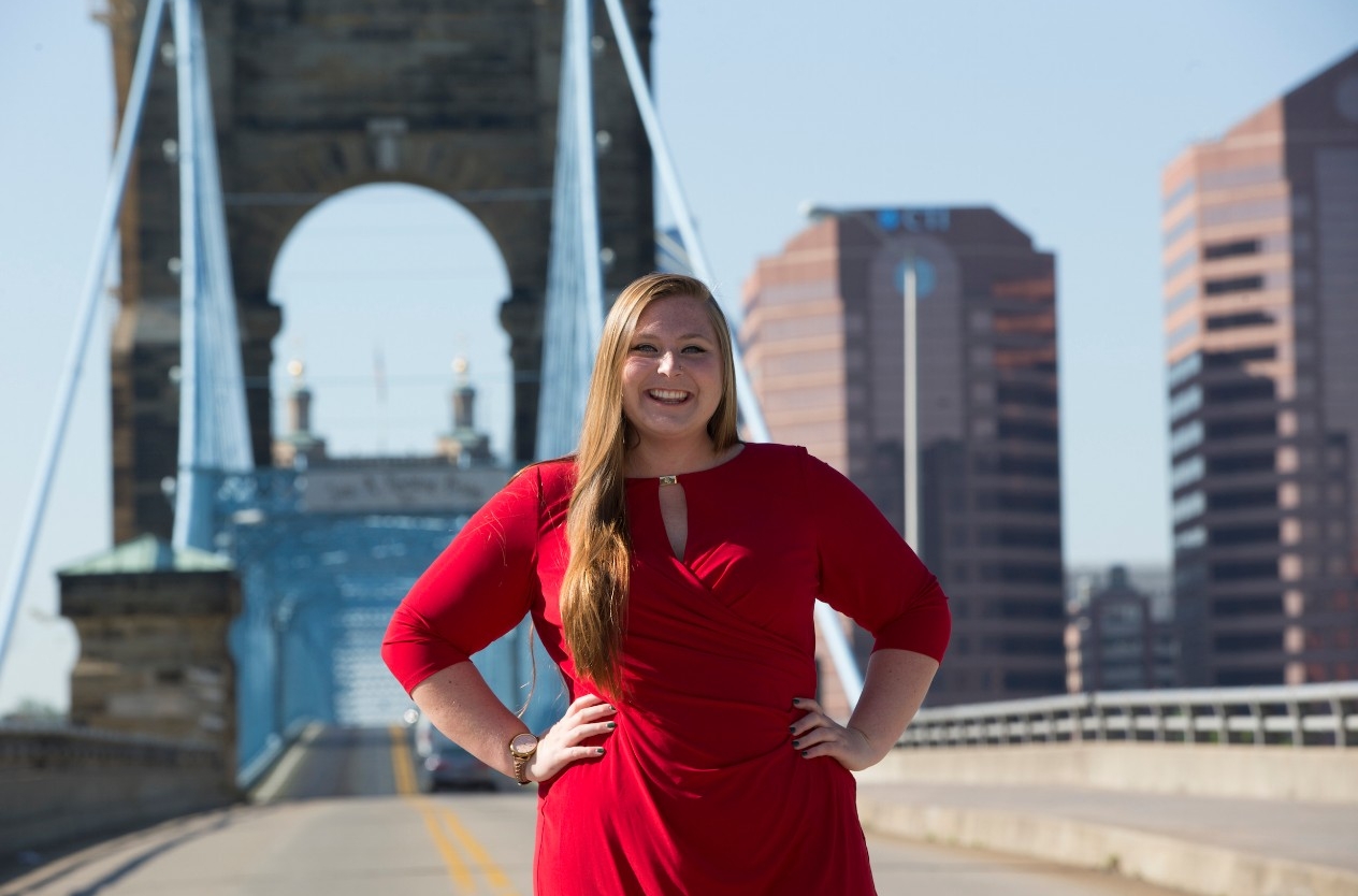 Brianna Karelin stands in front of Cincinnati's suspension bridge