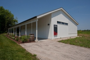 A white barn-like multiuse Court Archaeological Research Facility opened in the spring of 2013 thanks to donors. 