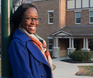 UC student N'deye Ba poses in front of the special first-generation housing.