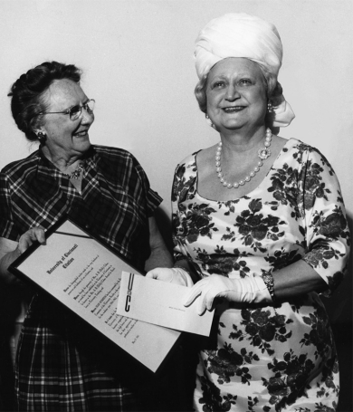 A vintage photograph from 1965 of UC benefactor Dolly Cohen presenting an award to UC teacher Jean Winston.