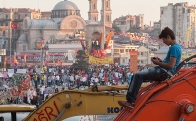 Boy on a piece of construction equipment in the midst of the protest in Turkey