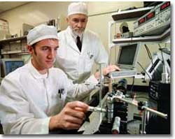 Andrew Steckl and a graduate student work in UC's clean room. photo/Dottie Stover