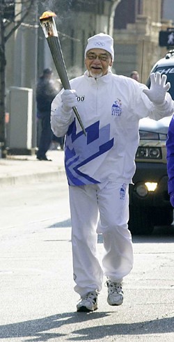 Dayton community leader Clark Beck,  Eng '55, MS (Eng) '69, was invited to carry  the Olympic torch through the Montgomery  County city's downtown streets before it  reachd the 2002 winter games in Salt Lake.  photo/Lisa Ventre