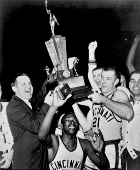 Bearcats coach Ed Jucker and Bob Wiesenhahn (No. 21) hoist the 1961 national championship trophy