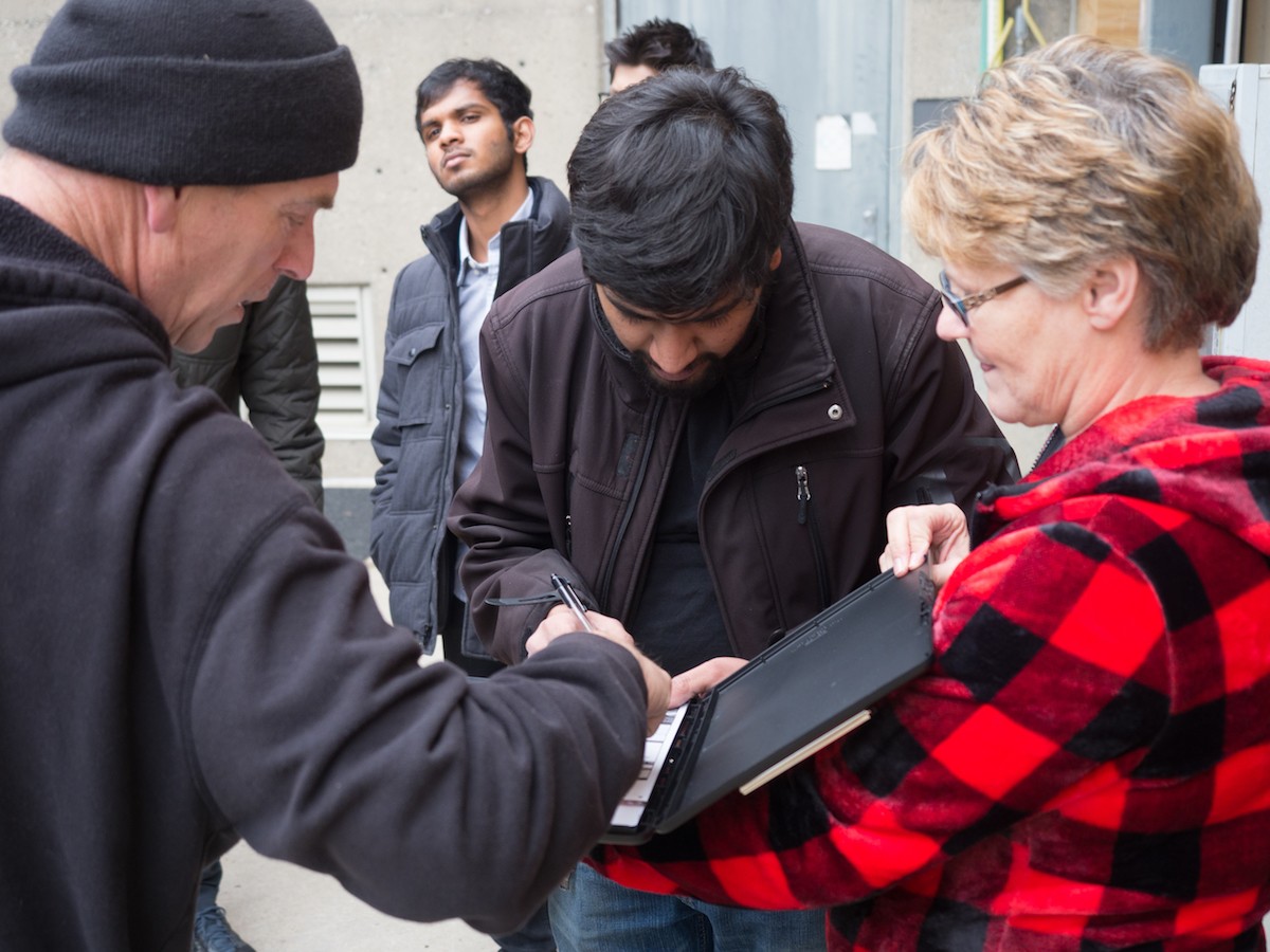 Hyperloop UC Presidnet Dhaval Shiyani signs the shipping manifest before sending the prototype west to California.