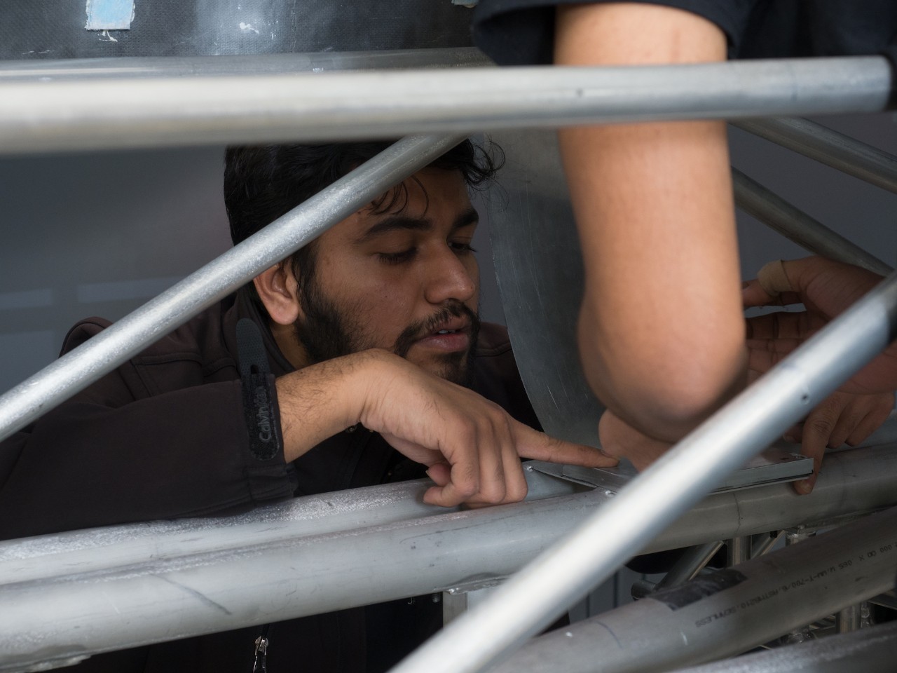 Hyperloop UC team leader Dhaval Shiyani inspects the details of their space frame in the final week before shipping it to California.